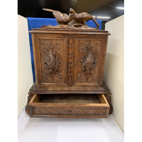 3 - A HEAVILY CARVED ANTIQUE WALNUT BLACK FOREST CIGAR HUMIDOR WITH BIRD DECORATION AND LOWER DRAWER