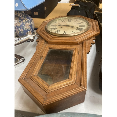 45 - AN ANTIQUE OCTAGONAL LONG DROP OAK WALL CLOCK WITH PENDULUM AND KEY