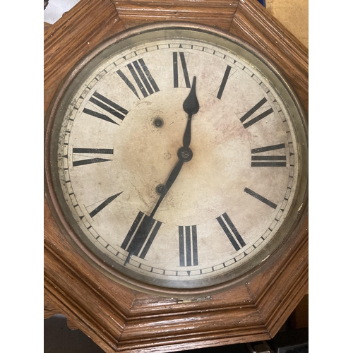 45 - AN ANTIQUE OCTAGONAL LONG DROP OAK WALL CLOCK WITH PENDULUM AND KEY