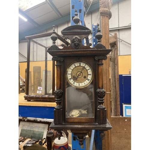 67 - AN EARLY MAHOGANY CASED WALL CLOCK WITH ENAMEL AND GILT FACE, CARVING TO THE COLUMNS AND TOP, ENDULU... 