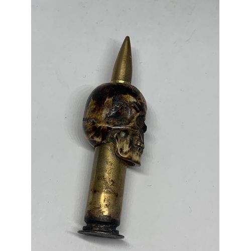 480A - A TRENCH ART BONE SKULL AND BULLET