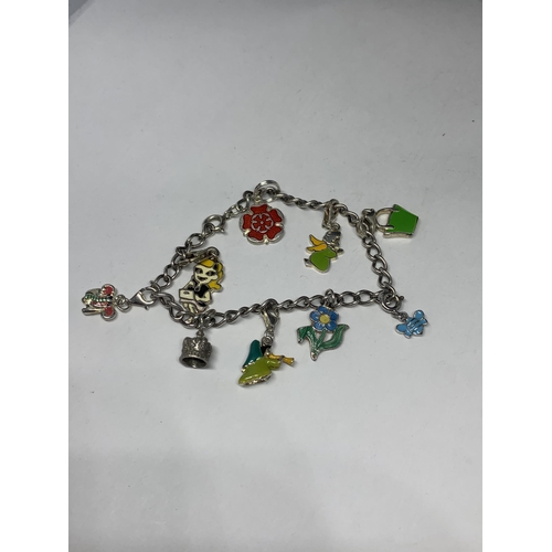 556 - A SILVER CHARM BRACELET WITH NINE CHARMS