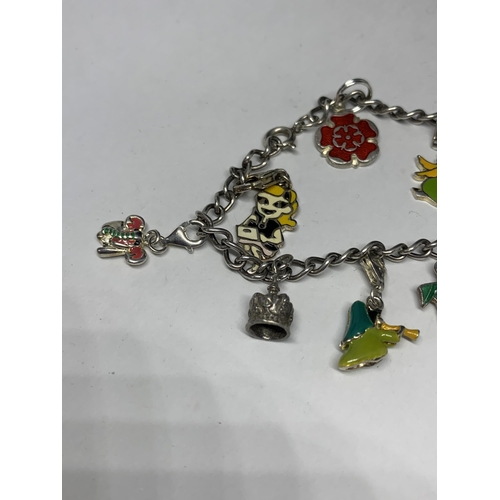 556 - A SILVER CHARM BRACELET WITH NINE CHARMS