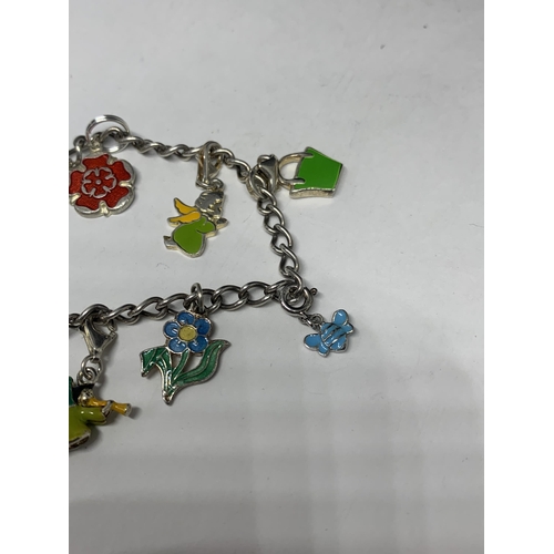 556 - A SILVER CHARM BRACELET WITH NINE CHARMS