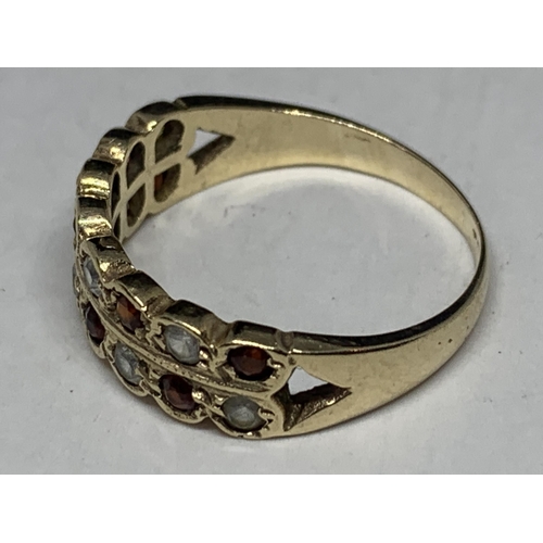 560 - A 9 CARAT GOLD RING WITH EIGHT GARNETS AND EIGHT CUBIC ZIRCONIAS SIZE O