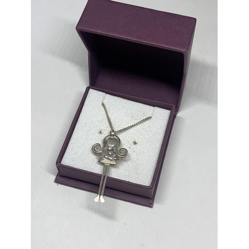 566 - A MARKED SILVER NECKLACE AND PENDANT IN THE FORM OF A GIRL IN A PRESENTATION BOX