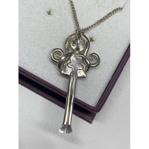 566 - A MARKED SILVER NECKLACE AND PENDANT IN THE FORM OF A GIRL IN A PRESENTATION BOX