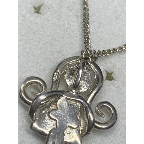 566 - A MARKED SILVER NECKLACE AND PENDANT IN THE FORM OF A GIRL IN A PRESENTATION BOX