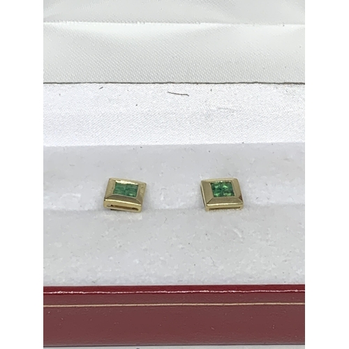 599 - A PAIR OF MARKED 9 CARAT GOLD SQUARE EARRINGS WITH EMERALDS IN A PRESENTATION BOX