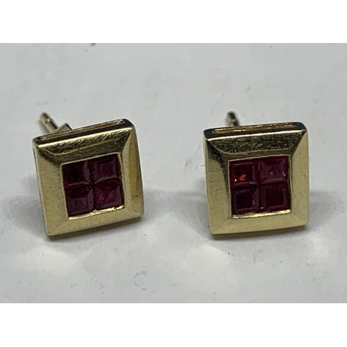 600 - A PAIR OF MARKED 9 CARAT GOLD SQUARE EARRINGS WITH RUBYS IN A PRESENTATION BOX