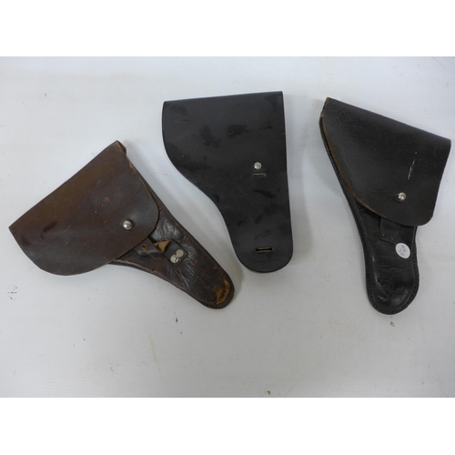 275 - THREE LEATHER PISTOL HOLSTERS