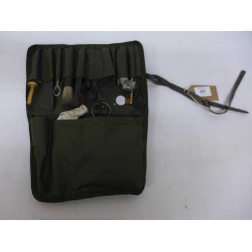 287 - A MILITARY POUCH CONTAINING GUN CLEANING AND MAINTENANCE KIT