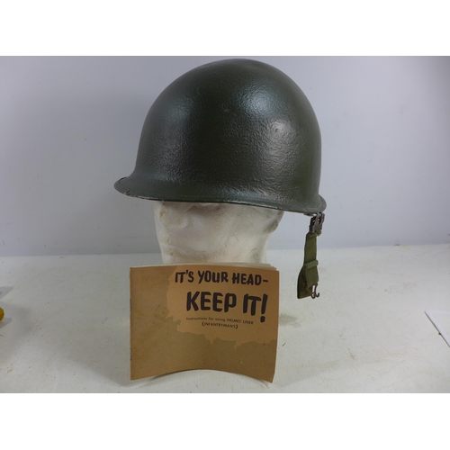 454 - A USA INFANTRYMAN'S HELMET AND LINER, TOGETHER WITH AN INSTRUCTION BOOKLET