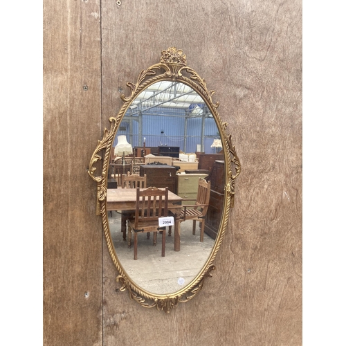 2984 - AN OVAL GILT METAL EFFECT WALL MIRROR, 26