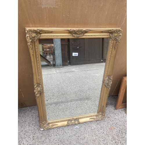 2989 - A GILT FRAMED WALL MIRROR, 35