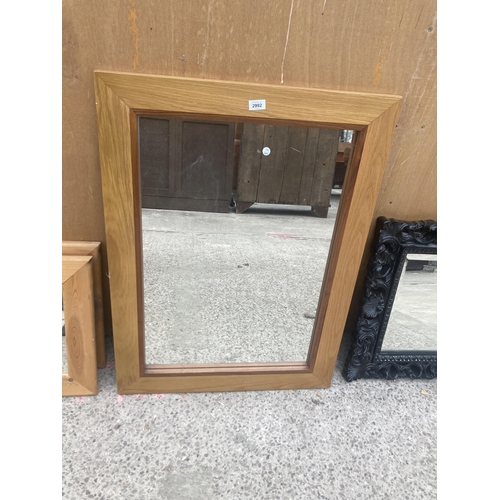 2992 - A MORRIS FURNITURE OAK FRAMED WALL MIRROR, 37