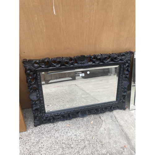 2994 - A 19TH CENTURY ROCOCO STYLE BLACK WALL MIRROR WITH BEVEL EDGE, 35