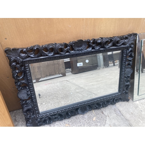 2994 - A 19TH CENTURY ROCOCO STYLE BLACK WALL MIRROR WITH BEVEL EDGE, 35