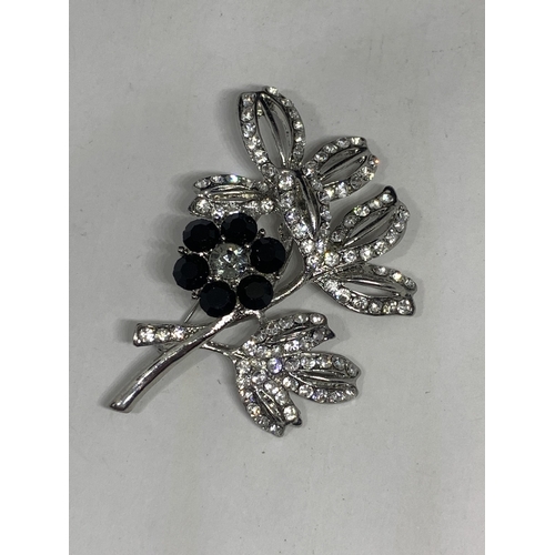 575 - AN AVALAYA BLACK CRYSTAL FLORAL BROOCH