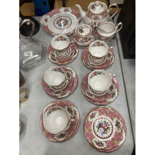 33 - A ROYAL ALBERT LADY CARLYLE TEASET TO INCLUDE TEAPOT, SUGAR AND CREAMER, CAKE PLATE, FIVE TRIO, SAUC... 