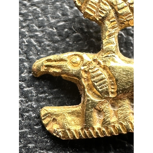 300 - A GOLD ELEPHANT AND PALM TREE BADGE TESTED TO 18 CARAT BUT BELIEVED 24 CARAT, POSSIBLY WW2 GERMAN AF... 