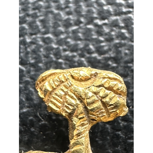 300 - A GOLD ELEPHANT AND PALM TREE BADGE TESTED TO 18 CARAT BUT BELIEVED 24 CARAT, POSSIBLY WW2 GERMAN AF... 