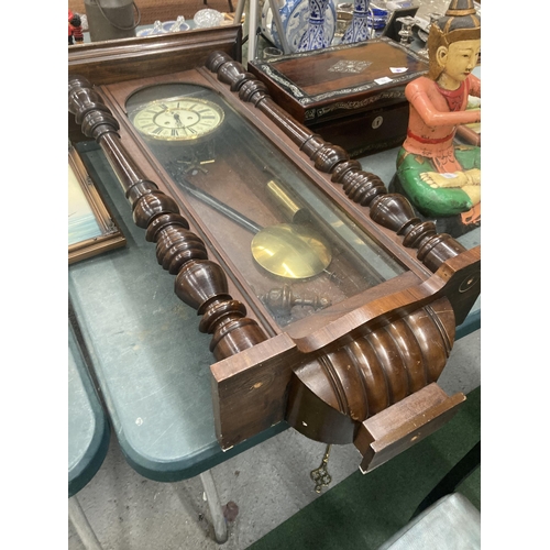 74 - A LONG CASE WALL CLOCK WITH PENDULUM AND WEIGHTS IN MAHOGANY CASING