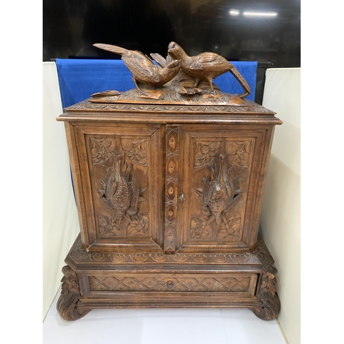 3 - A HEAVILY CARVED ANTIQUE WALNUT BLACK FOREST CIGAR HUMIDOR WITH BIRD DECORATION AND LOWER DRAWER