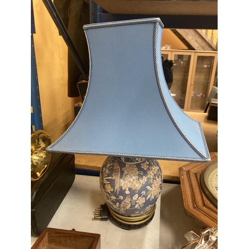 46 - AN ORIENTAL LAMP BASE WITH BLUE SHADE