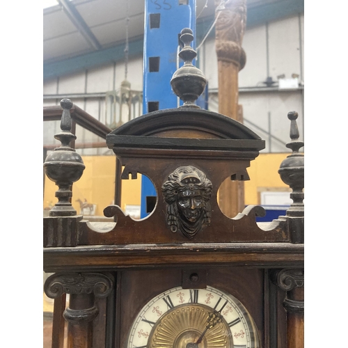 67 - AN EARLY MAHOGANY CASED WALL CLOCK WITH ENAMEL AND GILT FACE, CARVING TO THE COLUMNS AND TOP, ENDULU... 