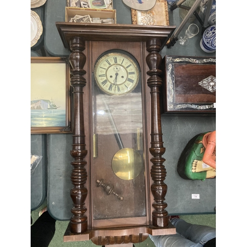 74 - A LONG CASE WALL CLOCK WITH PENDULUM AND WEIGHTS IN MAHOGANY CASING