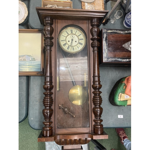 74 - A LONG CASE WALL CLOCK WITH PENDULUM AND WEIGHTS IN MAHOGANY CASING