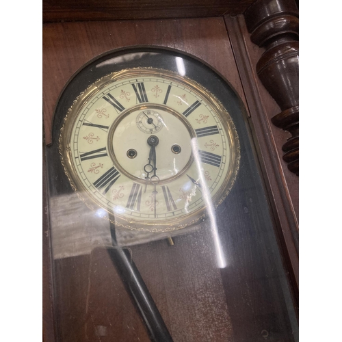 74 - A LONG CASE WALL CLOCK WITH PENDULUM AND WEIGHTS IN MAHOGANY CASING