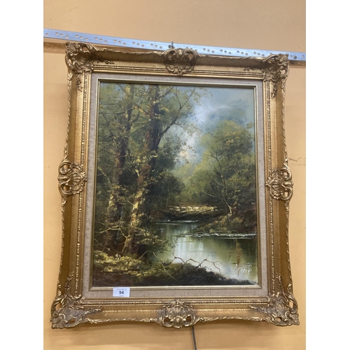 94 - TWO OIL PAINTINGS TO INCLUDE A GILT FRAMED OIL ON BOARD OF A MOUNTAINOUS, WOODLAND, LAKE SCENE SIGNE... 