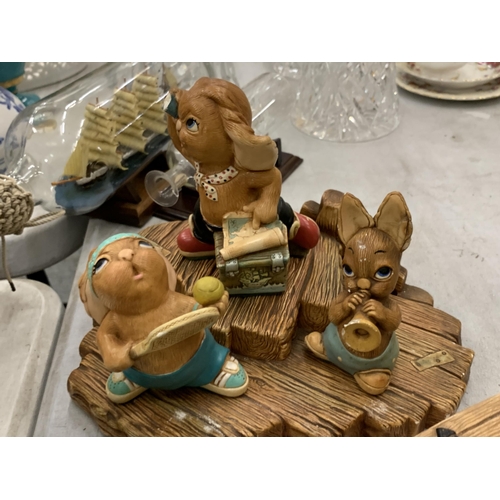 208 - A COLLECTION OF PENDELFIN RABBITS PLUS A DISPLAY STAND