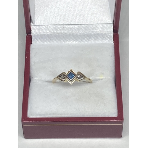 533 - A MARKED 14 CARAT GOLD RING WITH CENTRE SAPPHIRE WITH A DIAMOND EACH SIDE SIZE M GROSS WEIGHT 1.77 G... 