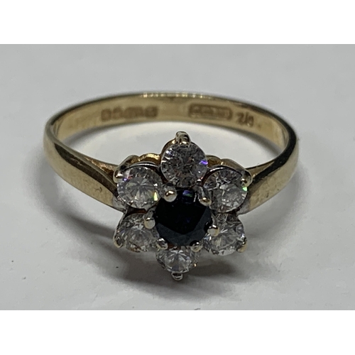 558 - A 9 CARAT GOLD RING WITH CENTRE SAPPHIRE SURROUNDED BY CUBIC ZIRCONIAS SIZE N