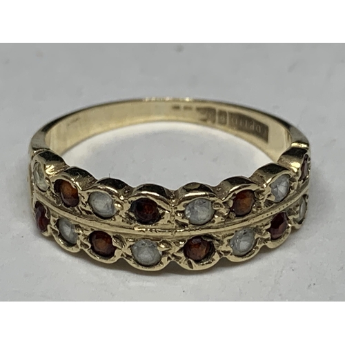 560 - A 9 CARAT GOLD RING WITH EIGHT GARNETS AND EIGHT CUBIC ZIRCONIAS SIZE O