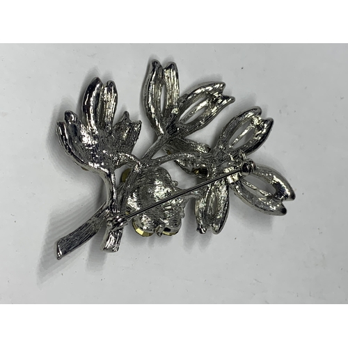 575 - AN AVALAYA BLACK CRYSTAL FLORAL BROOCH