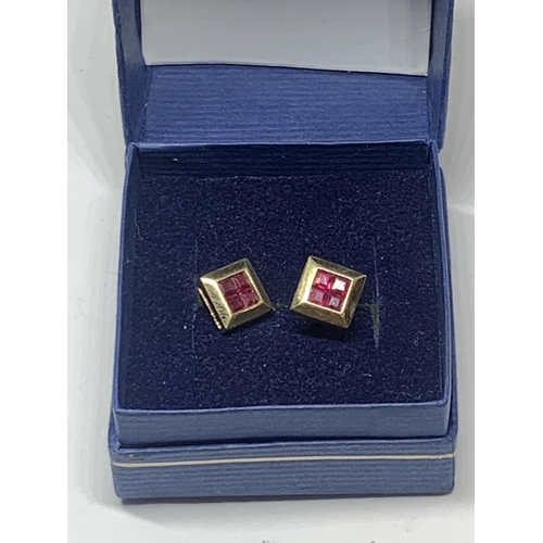 600 - A PAIR OF MARKED 9 CARAT GOLD SQUARE EARRINGS WITH RUBYS IN A PRESENTATION BOX