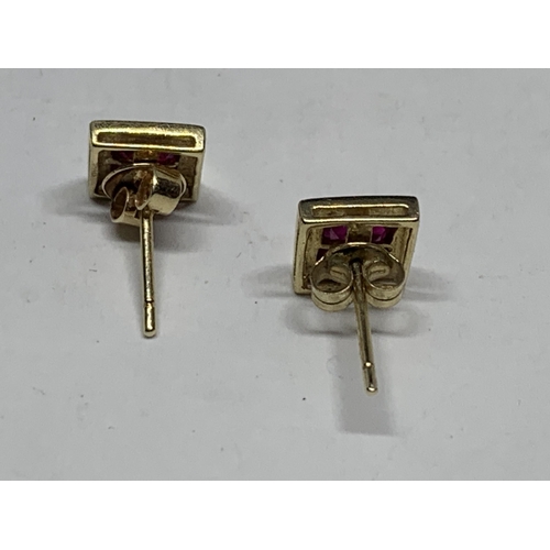 600 - A PAIR OF MARKED 9 CARAT GOLD SQUARE EARRINGS WITH RUBYS IN A PRESENTATION BOX