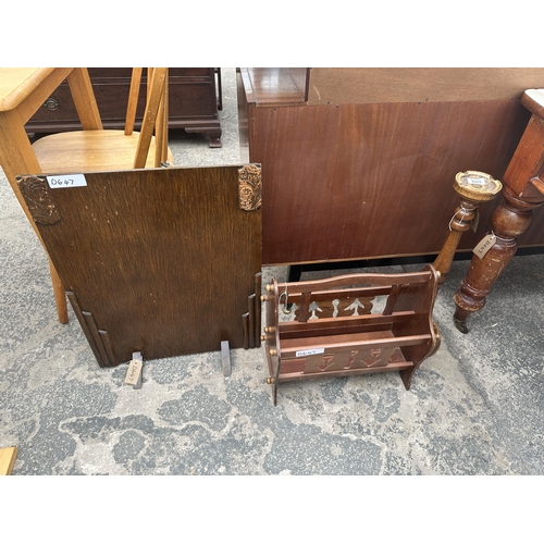 2933 - AN OAK FIRESCREEN, MAGAZINE RACK AND AN ASH TRAY STAND