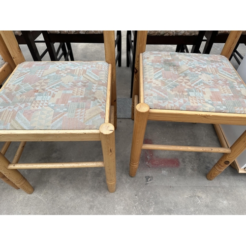 2945 - A SET OF FOUR PINE DINING CHAIRS WITH CURVED BACK RAILS