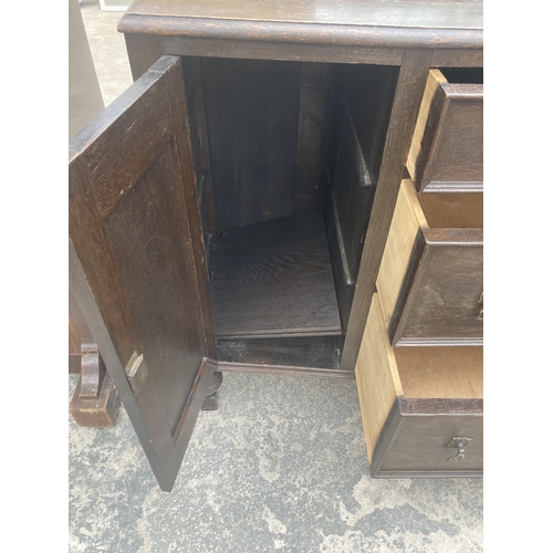 3007 - AN EARLY 20TH CENTURY OAK SIDEBOARD ENCLOSING THREE DRAWERS, TWO CUPBOARDS, 51