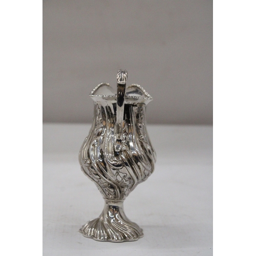 14 - A HALLMARKED BIRMINGHAM SILVER CREAM JUG WITH BALUSTER SHAPED BODY EMBOSSED WITH PANELS OF FLOWERING... 