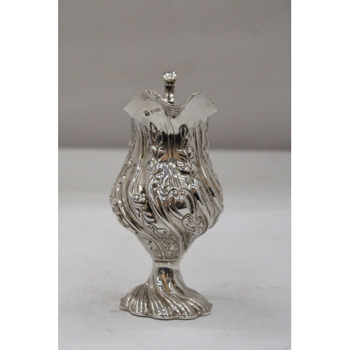 14 - A HALLMARKED BIRMINGHAM SILVER CREAM JUG WITH BALUSTER SHAPED BODY EMBOSSED WITH PANELS OF FLOWERING... 