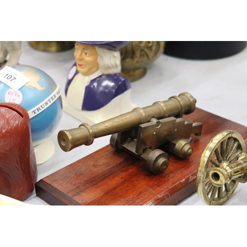 102 - A VINTAGE BRASS CANON ON A WOODEN PLINTH PLUS ONE OTHER