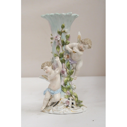 23 - AN EARLY 20TH CENTURY CONTINENTAL PORCELAIN FLORAL ENCRUSTED CANDLESTICK SURMOUNTED BY CHERUB FIGURE... 