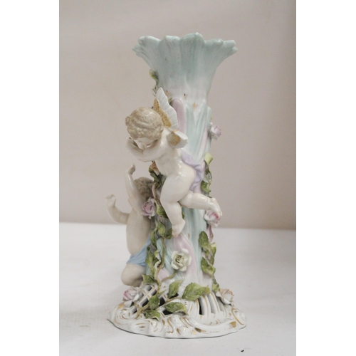 23 - AN EARLY 20TH CENTURY CONTINENTAL PORCELAIN FLORAL ENCRUSTED CANDLESTICK SURMOUNTED BY CHERUB FIGURE... 