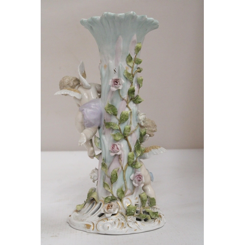 23 - AN EARLY 20TH CENTURY CONTINENTAL PORCELAIN FLORAL ENCRUSTED CANDLESTICK SURMOUNTED BY CHERUB FIGURE... 